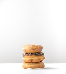 tower of assorted donuts isolated on white background