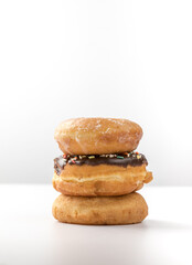 tower of assorted donuts isolated on white background