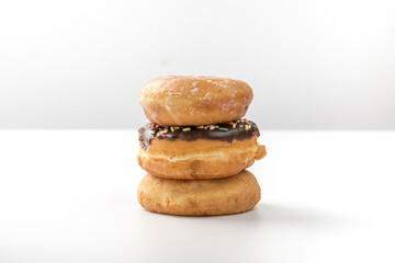 tower of assorted donuts isolated on white background
