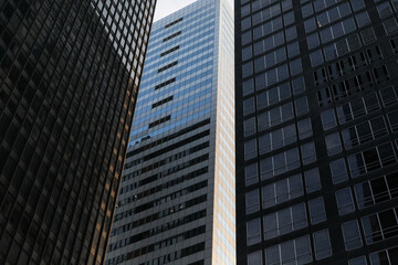 Stunning view of modern skyscrapers in Midtown Manhattan, New York City, under a clear blue sky....