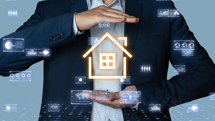 Businessman holding a glowing smart home icon with data interfaces floating around, futuristic IoT...