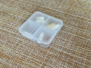 The weekly transparent pillbox is designed for convenient and efficient daily storage of dietary supplements and tablets. It has compartments with various types of capsules for administration.