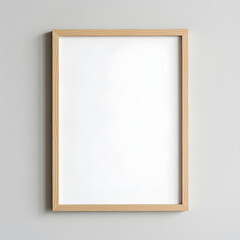 Mockup. An empty, wooden picture frame hangs against a neutral, light gray wall, ready for your art or print.