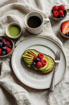Cheesecake and chocolate cake topped with fresh berries and mint on a dessert plate
