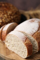 Fresh cut bread on wooden board, closeup