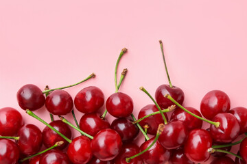 Fresh ripe cherries on pink background, flat lay. Space for text