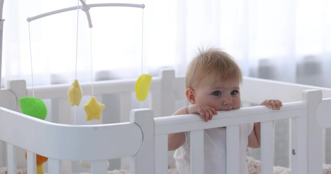 Cute little baby in crib at home, camera moving in