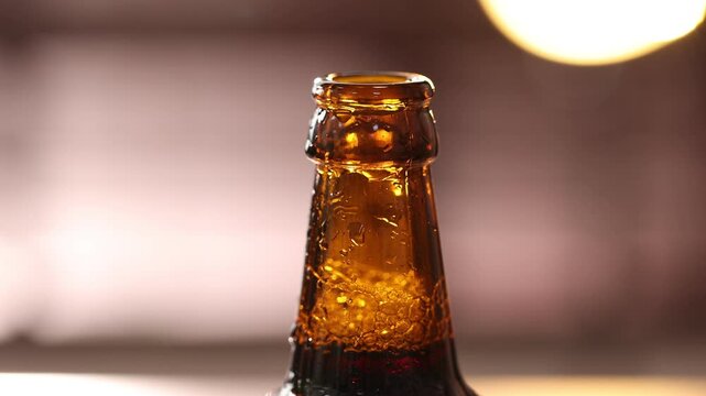 Woman opening bottle of beer on blurred brown background, closeup
