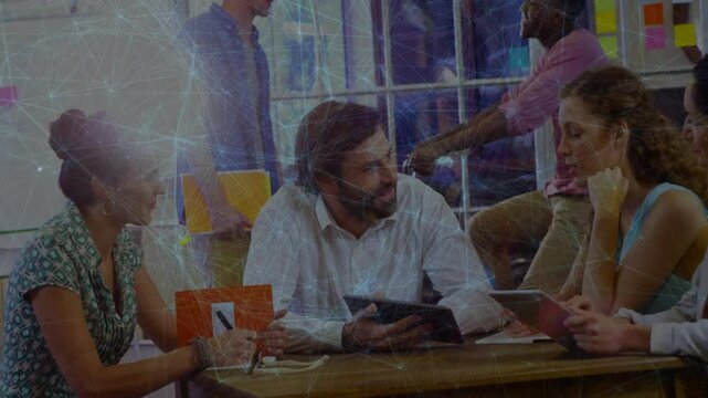 Notebook joting initiating tablet sharing and team referencing sticky notes in business meeting