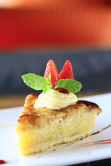 Vanilla cake topped with whipped cream and strawberries