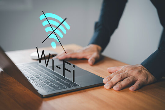 Male user using a laptop computer to connect to Wi-Fi, representing internet connectivity issues, network failure, offline mode, or technology disruption.