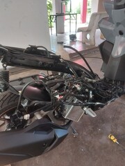 Disassembled motorbike frame and rim spraying in workshop