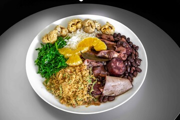 The best traditional Brazilian feijoada completely served in the most authentic style accompanied by the irresistible and iconic cachaça caipirinha