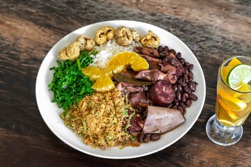 The best traditional Brazilian feijoada completely served in the most authentic style accompanied by the irresistible and iconic cachaça caipirinha