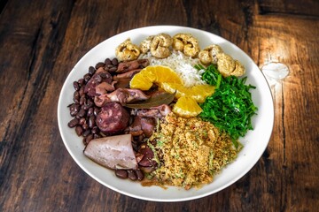 The best traditional Brazilian feijoada completely served in the most authentic style accompanied by the irresistible and iconic cachaça caipirinha