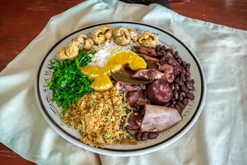 The best traditional Brazilian feijoada completely served in the most authentic style accompanied by the irresistible and iconic cachaça caipirinha