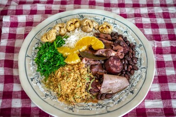 The best traditional Brazilian feijoada completely served in the most authentic style accompanied by the irresistible and iconic cachaça caipirinha