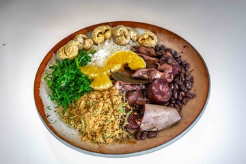 The best traditional Brazilian feijoada completely served in the most authentic style accompanied by the irresistible and iconic cachaça caipirinha