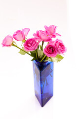 Roses in blue vase.