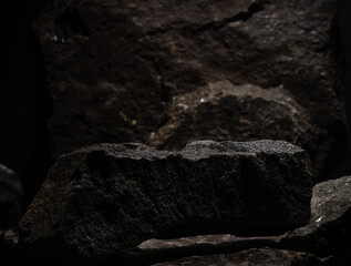 natural stones with texture on dark background for podium background presentation of cosmetics...