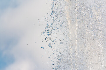 Splashes and jets of water against light background.