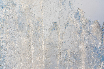 Splashes and jets of water against light background.