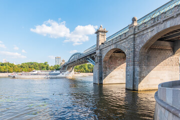 View of the Moscow river embankment, Pushkinsky bridge and cruise ships at sunset.