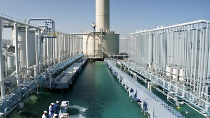 Industrial water treatment facility with workers.