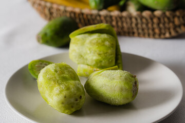 Peeled prickly pears resting on a white plate