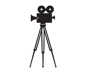 Silhouette of an old movie camera on a tripod. Vintage movie camera on tripod silhouette.