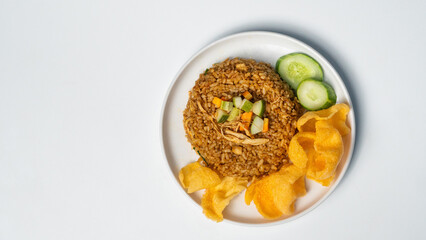 Savory Fried Rice Dish with Cucumber Slices and Crispy Crackers on White Plate, Top View