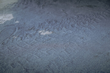 Close-up View of Footprints and Texture on a Sandy Surface