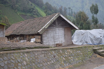 Rural scene of hillside homes and farmland under a cloudy sky