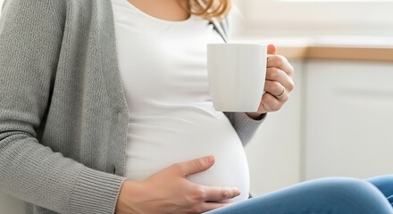 Expectant mother relaxing with a hot drink, cradling her baby bump in a cozy home setting