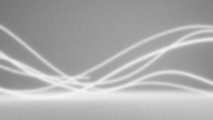 Obraz premium Soft light patterns cast on a textured gray surface creating abstract shadows and highlights