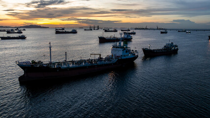 Aerial view oil tanker ship and gas tanker ship at sunset, Silhouette oil and gas tanker ship at...
