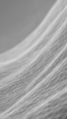Fototapeta premium Textured abstract background of flowing light and shadow patterns grey