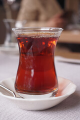 Freshly turkish tea served in a glass cup at a cozy cafe