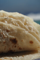 Delicious flatbread resting on a surface at midday