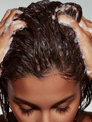 woman with long hair shampooing 