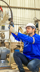 Male engineers checking or maintenance electronic in AI or artificial intelligence Robot, robot arm in the manufacturing automation and robotics manufacture room. Service technical engineer.