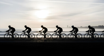 Obraz premium Cyclists ride in formation at dawn along a coastal path