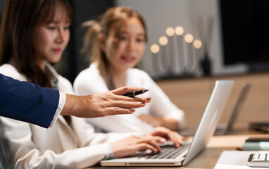 Focused female intern listening to senior  business woman mentor teacher explaining online strategy...