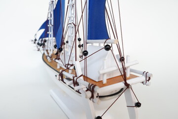 Miniature of a Traditional sailing boat made from wood and has blue sail