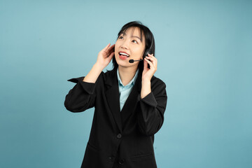 Professional woman with headset engaging in conversation against a blue background during a...