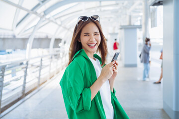 Woman using smartphone in public areas, During leisure time. The concept of using the phone is essential in everyday life.