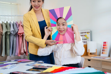 Young Asian woman doing personal color diagnosis by Face frames Color Season Kit for determining...
