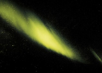 Vibrant yellow beam creating abstract aurora pattern resembling bird head silhouette against grainy dark backdrop, vintage film aesthetic with dramatic monochrome lighting.