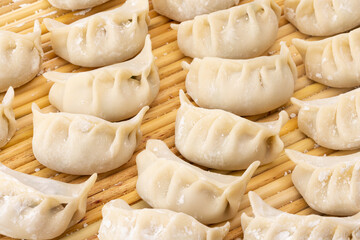 close up of some freshly hand-wrapped raw dumplings