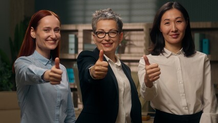Caucasian Asian Korean multiethnic women showing thumbs up recommend office females successful feedback good diversity team gesture businesswomen colleagues agree business multiracial girls smiling
